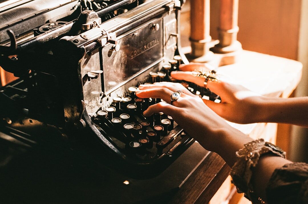 Close up of hands typing on an old typewriter